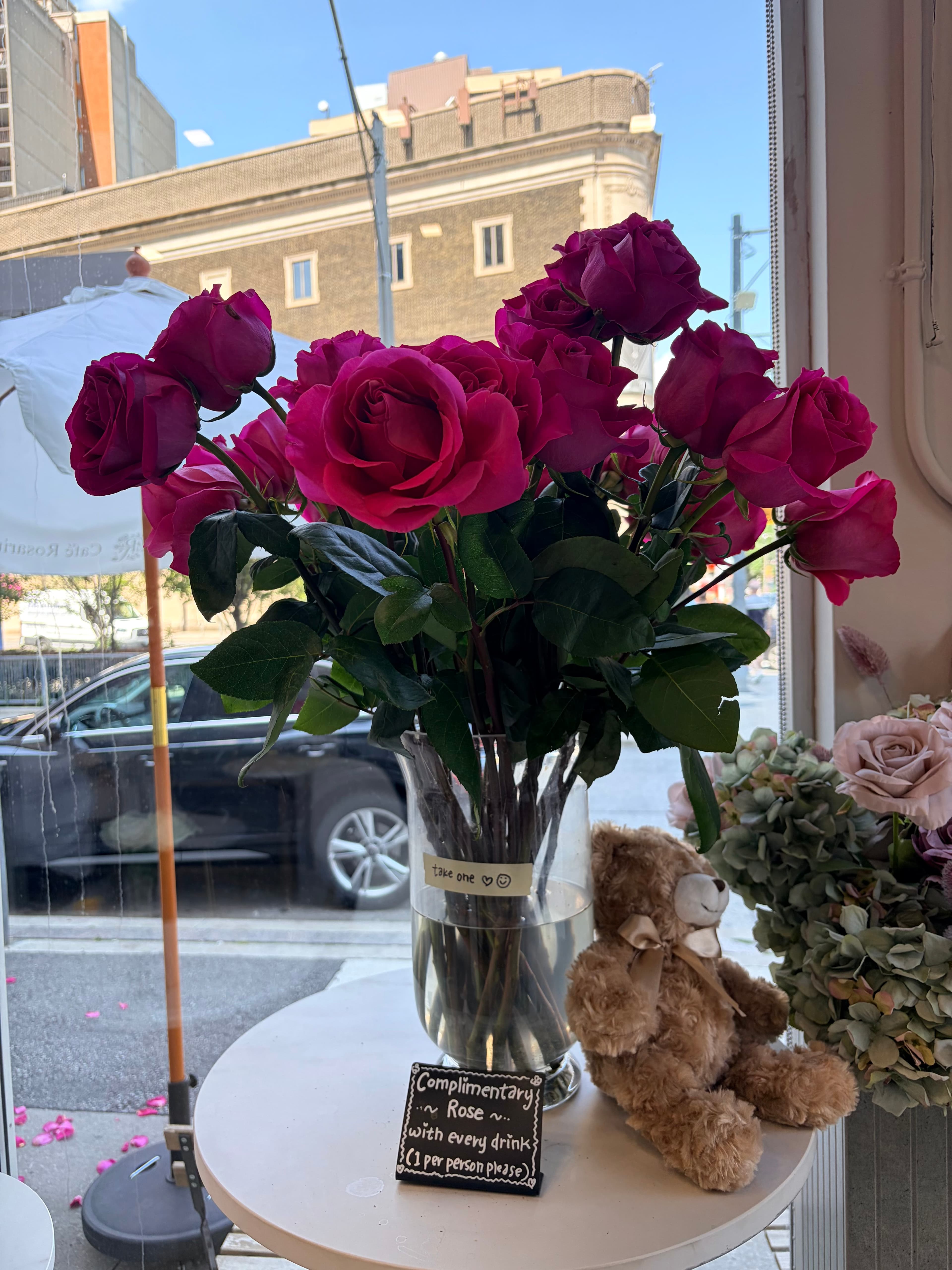 Complimentary roses in a café window