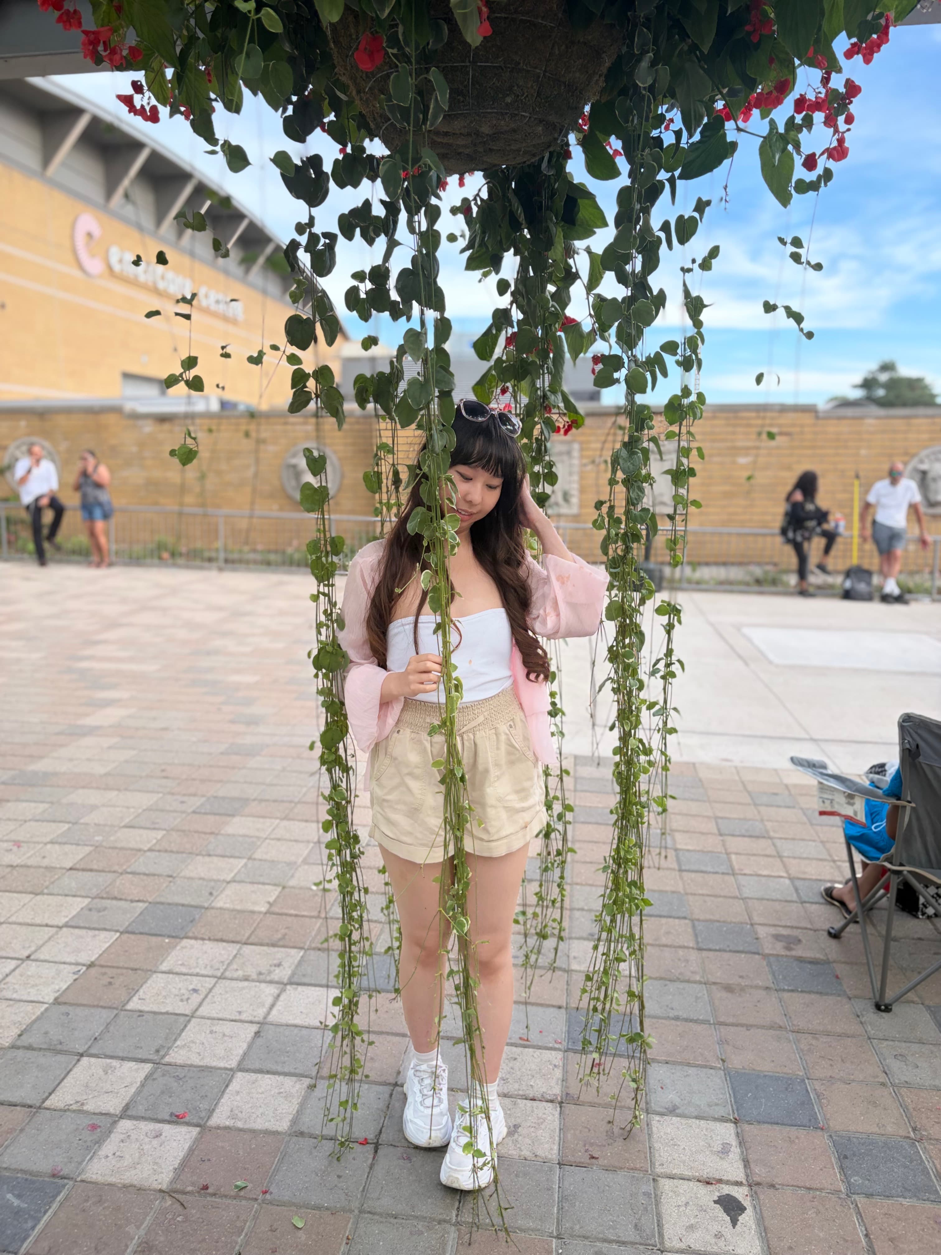 Amy standing under hanging vines near Ontario Place